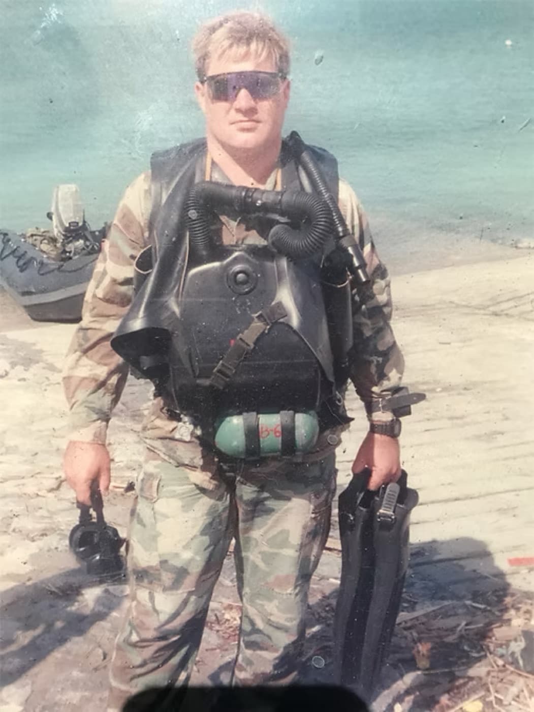 Michael Gilbert in combat dive gear with a closed-circuit rebreather and fins during maritime special operations training